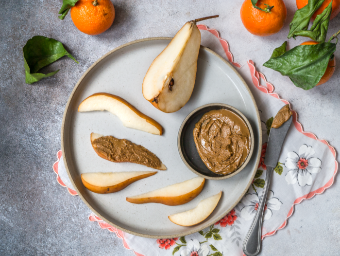 sliced pears and almond butter on knife